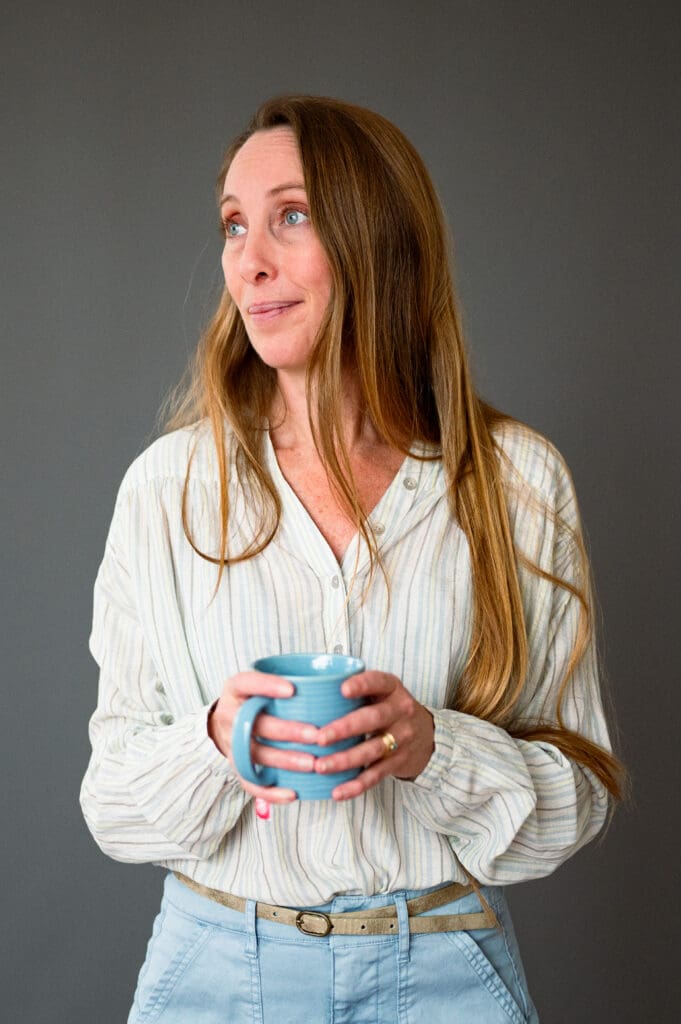 Color portrait of a Big Talk participant holding a blue mug and looking off to the side