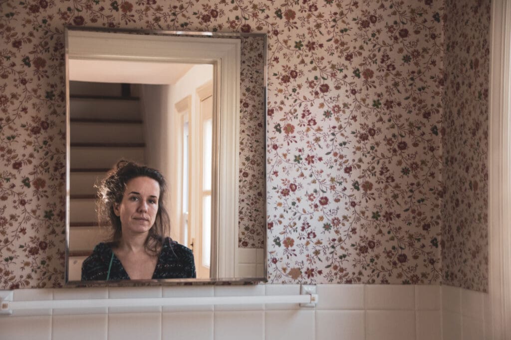 A raw, unposed self-portrait taken during the Home Alone project, capturing vulnerability and everyday beauty in solitude.