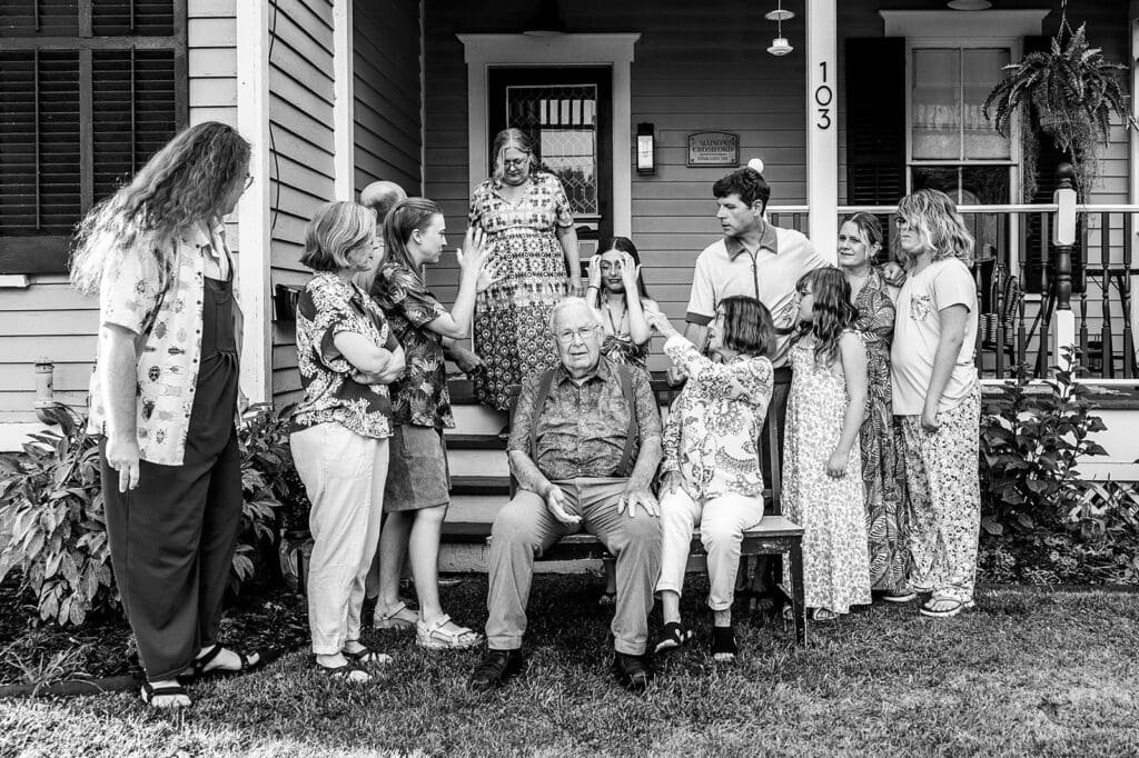 Multi-generational family gathered on the porch for a documentary-style group photo