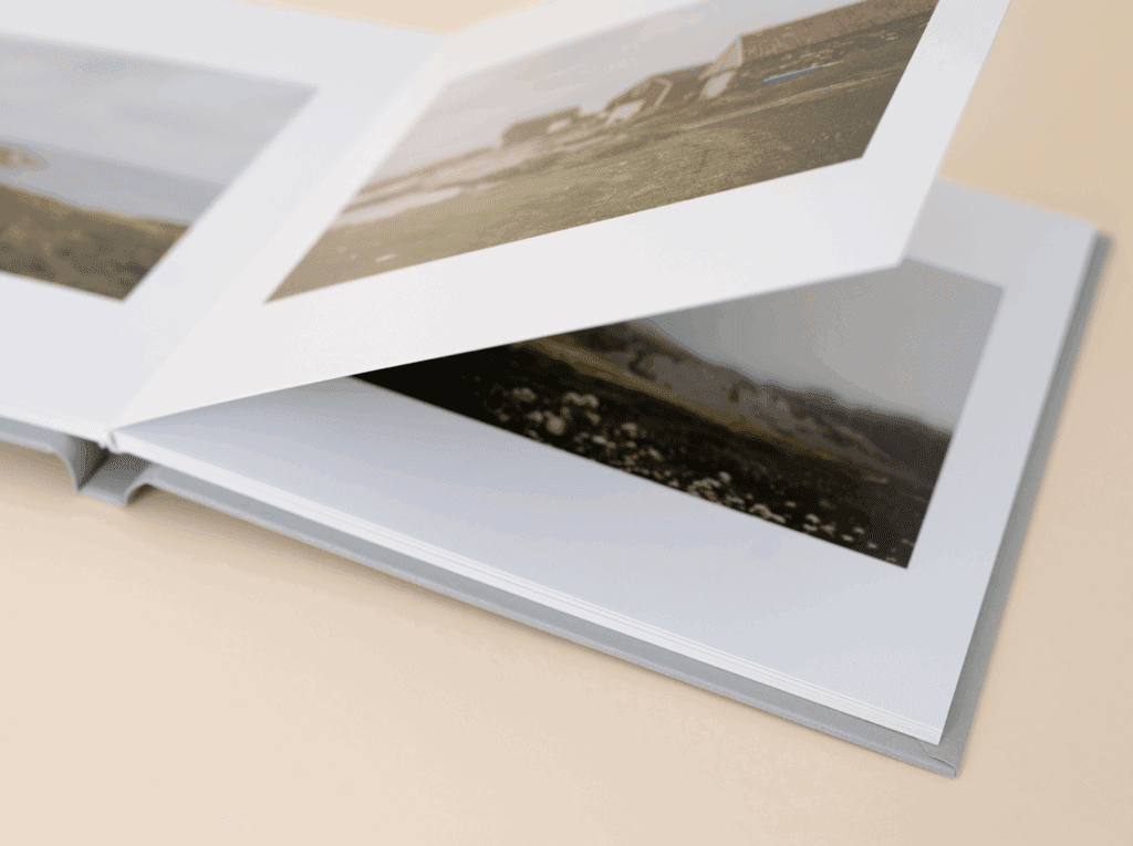 Open linen-bound family photo album displaying printed images