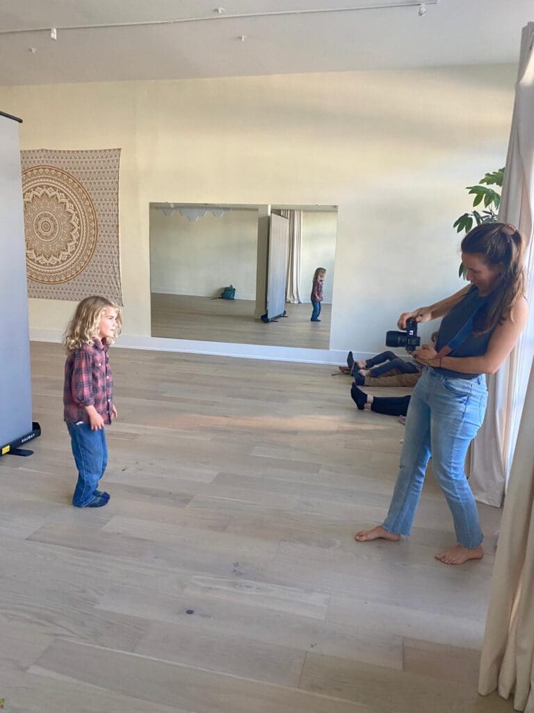 Photographer capturing a child’s portrait during a five-minute Short & Sweet fine art children’s session with natural light backdrop