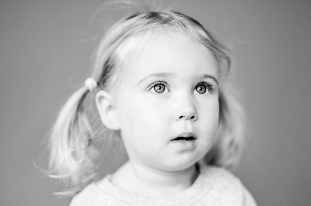 Fine art children’s portrait in natural light with simple backdrop