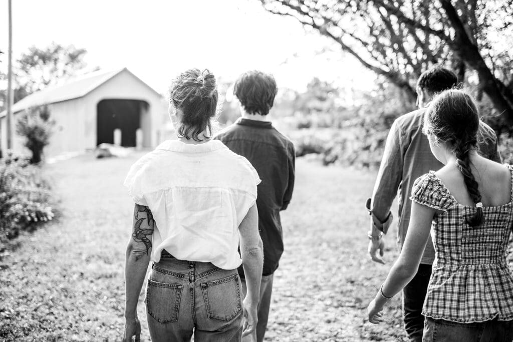A family walking together away from the camera during an unposed lifestyle family photography session