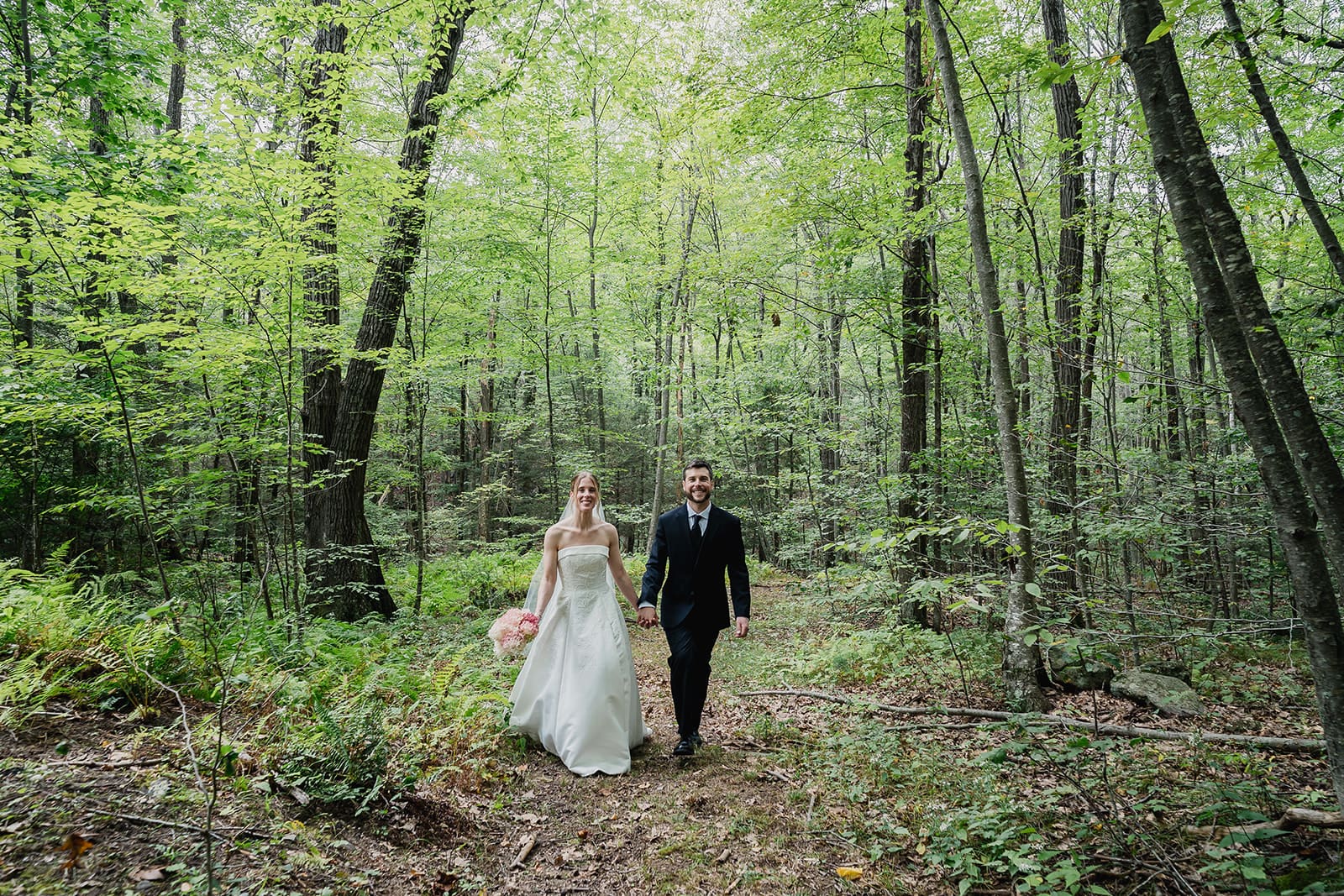 couple walking together through the woods during an outdoor elopement capturing a natural and relaxed moment