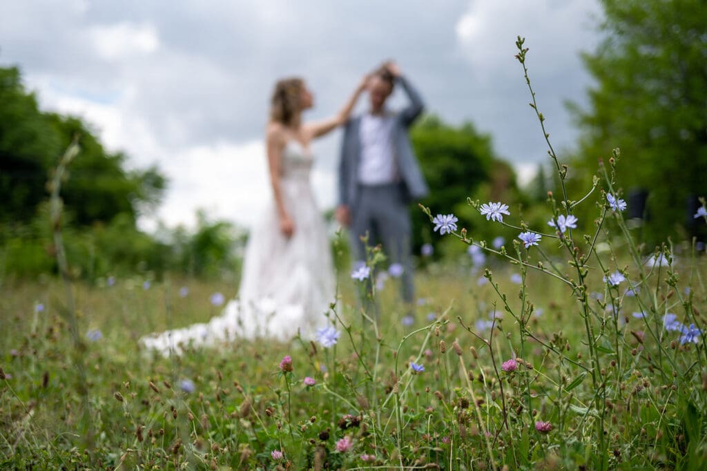 couple standing together in a wildflower field during an outdoor elopement session