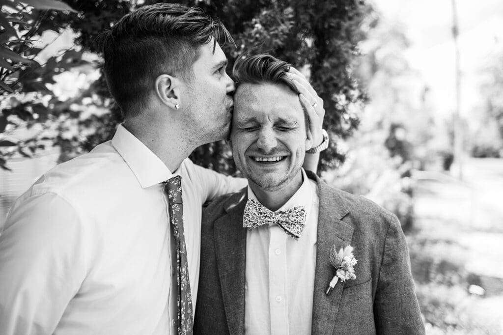 two grooms smiling together during an elopement capturing a candid and connected moment