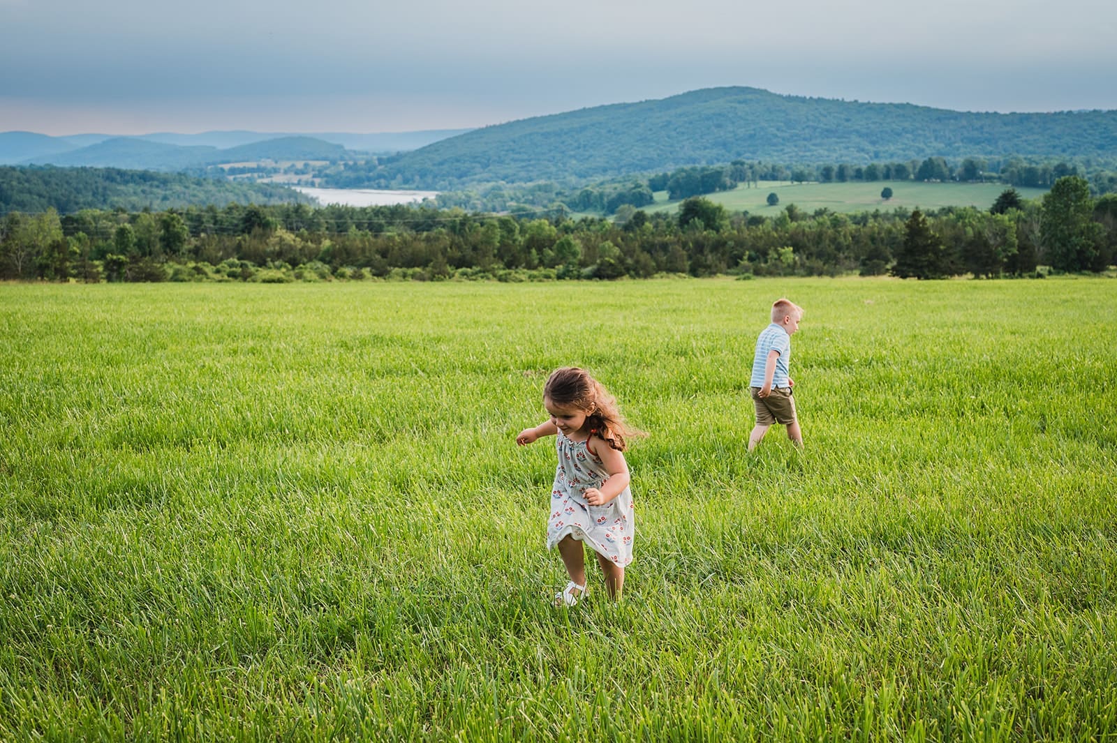 kids running through open field during Hudson Valley family vacation photography session